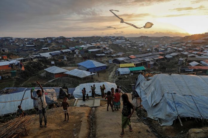 Rohingya refugee children fly improvised kites at the Kutupalong refugee camp near Cox's Bazar, Bangladesh