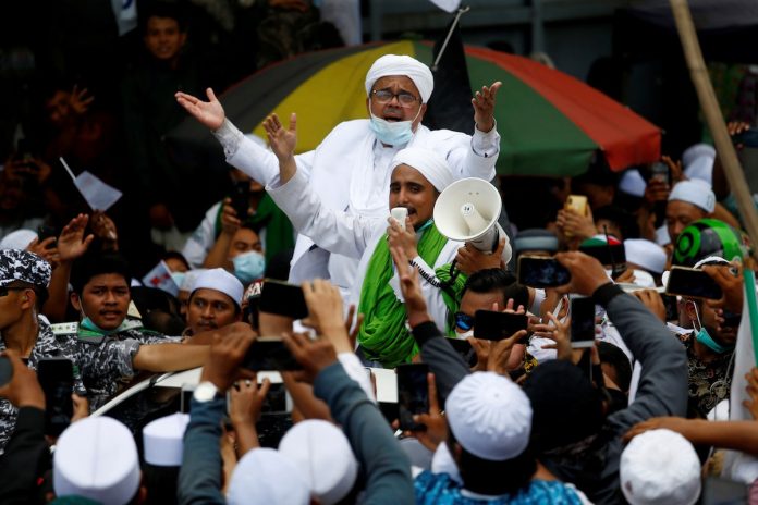 Rizieq Shihab, the leader of Indonesian Islamic Defenders Front (FPI), is greeted by supporters at the Tanah Abang, Jakarta, Indonesia, Nov. 10. (Photo by Ajeng Dinar Ulfiana/Reuters)