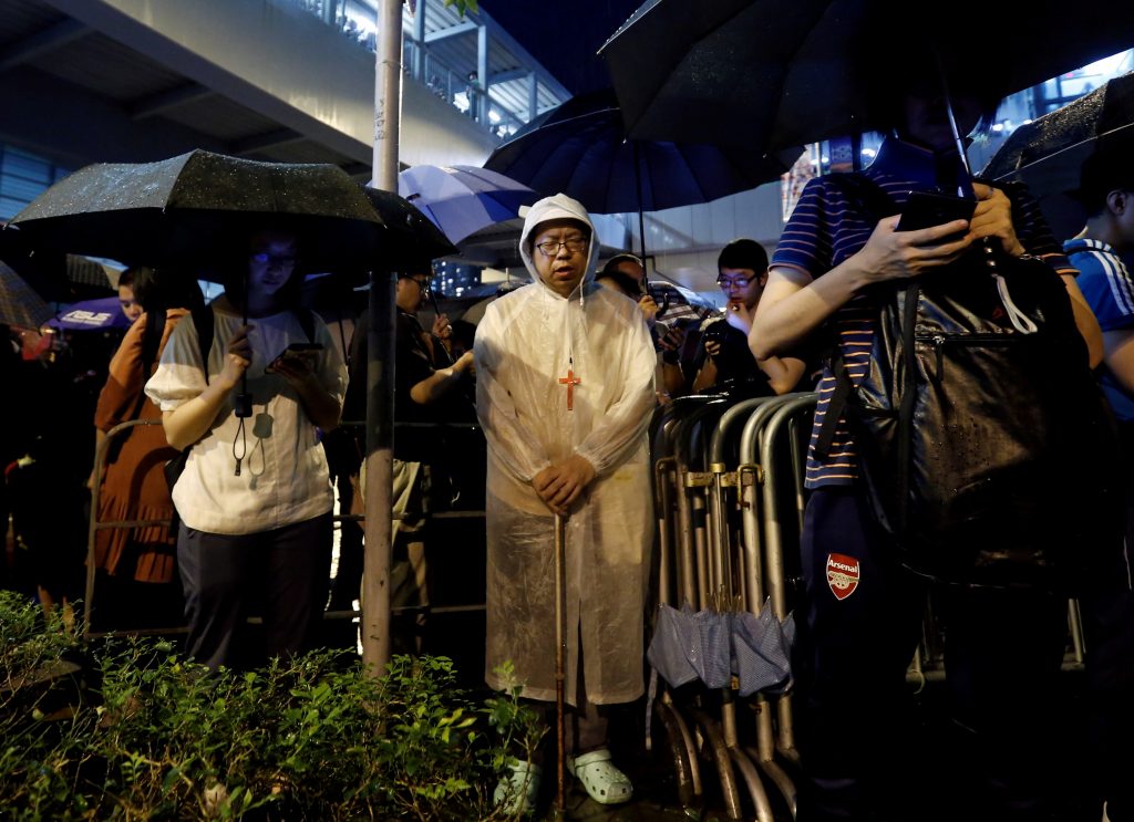 Faithful attend a Catholic service outside the Legislative Council building as they protest the extradition bill with China in Hong Kong, China, on June 11, 2019. (Reuters photo)