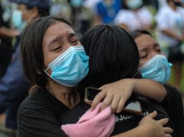 A family member cries in grief at the funeral of mother and son Sonia and Frank Anthony Gregorio, who were killed by a police officer in the province of Tarlac on Dec. 20. (Photo by Jire Carreon)