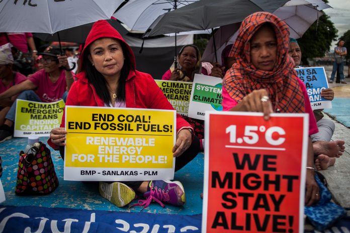 Pro-environment activists hold a demonstration calling for an end to the use of dirty energy in Manila in this photo taken in 2019. (File photo by Mark Saludes)