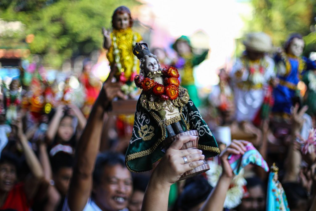 A devotee raises an image of the Child Jesus during the annual observance of the ‘feast’ of the Santo Niño in Manila’s Tondo district in 2020. (File photo by Jire Carreon)