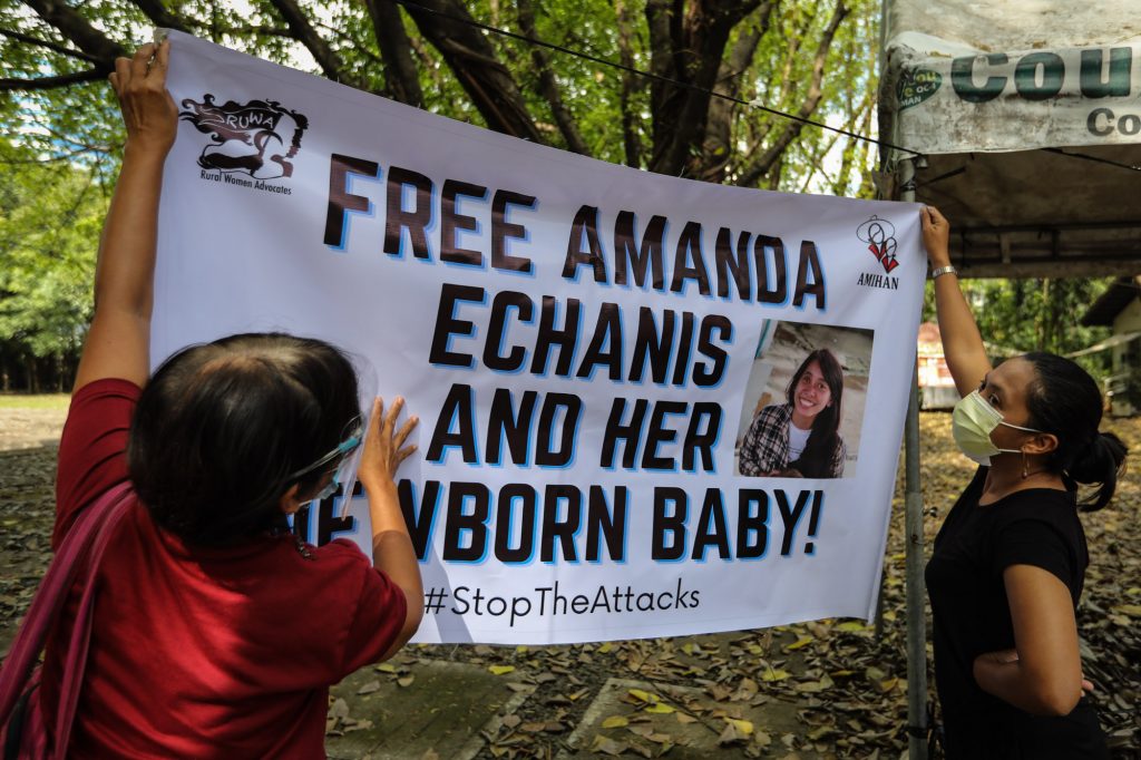 Activists hang a poster calling for the released of activist Amanda Echanis during a media briefing in Quezon City on Dec. 9, 2020. (Photo by Jire Carreon)