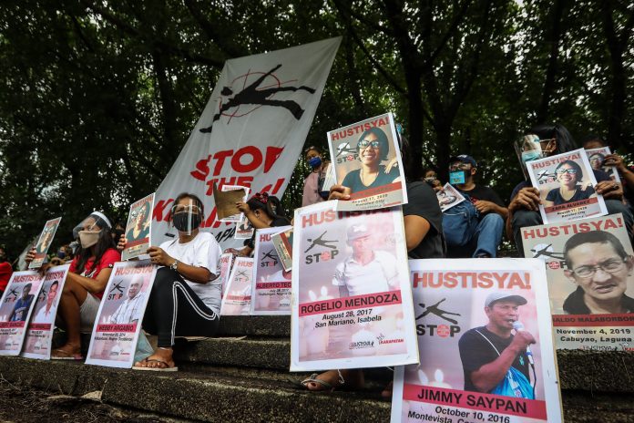 Human rights groups display photographs of activists who were reported killed in the Philippines in recent months during a demonstration in Quezon City on Aug. 19, 2020. (Photo by Jire Carreon)