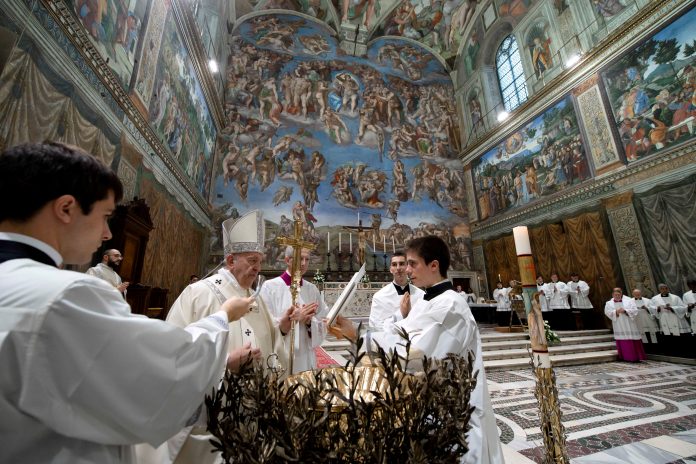 Pope Francis leads a Mass to baptize babies in the Sistine Chapel at the Vatican on Jan. 12, 2020. (Vatican Media handout via Reuters)