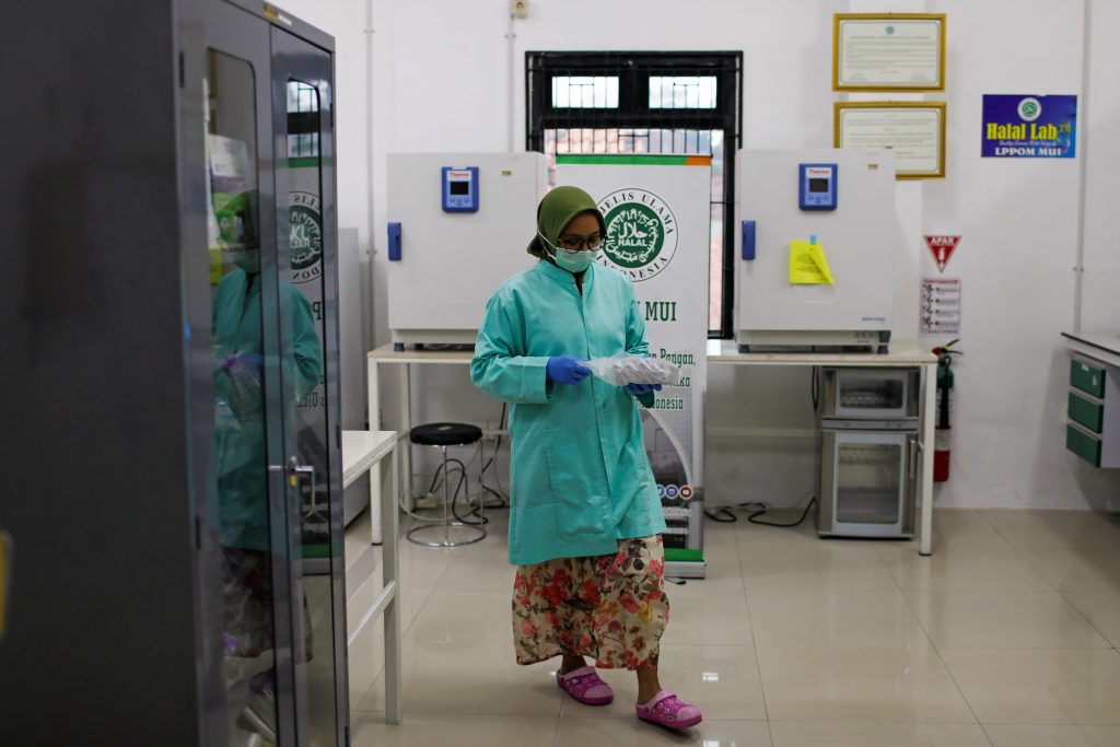 An analyst of Global Halal Center walks inside a laboratory, where the Sinovac's vaccine for COVID-19 was analyzed for Halal certification, in Bogor, Indonesia, Jan. 6. (Photo by Willy Kurniawan/Reuters)