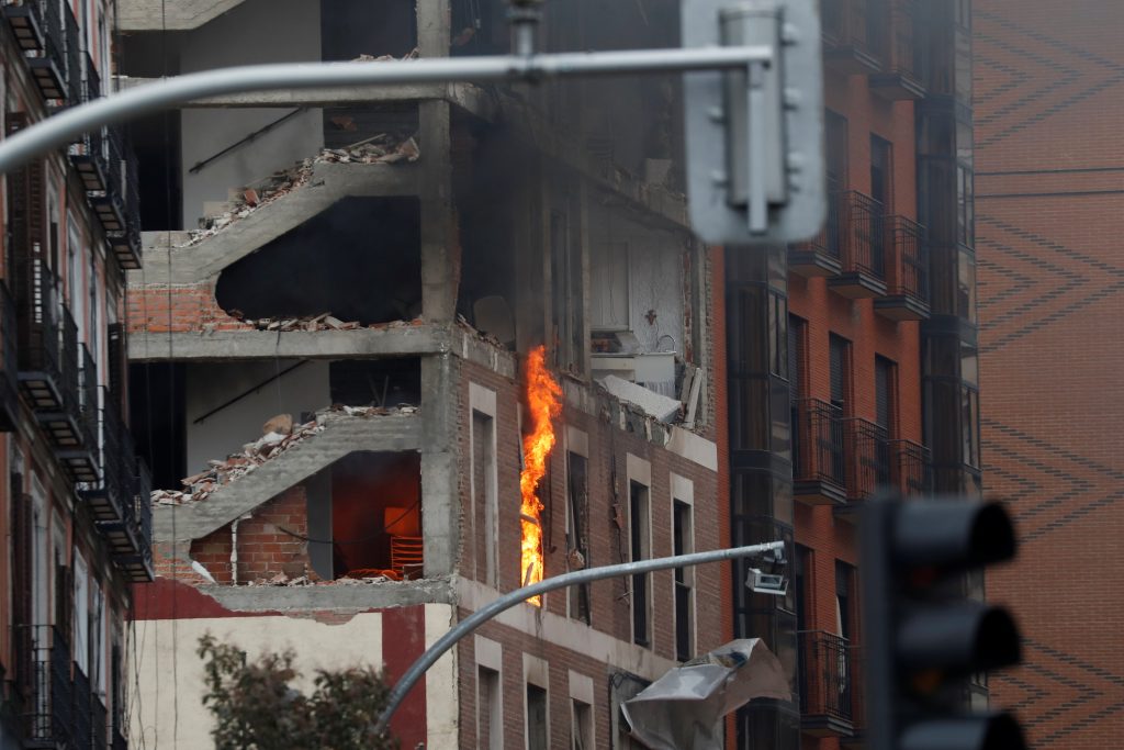 The building belonging to the Catholic Church burns after a deadly explosion, in Madrid downtown, Spain on Jan. 20, 2021. (Photo by Susana Vera / Reuters)