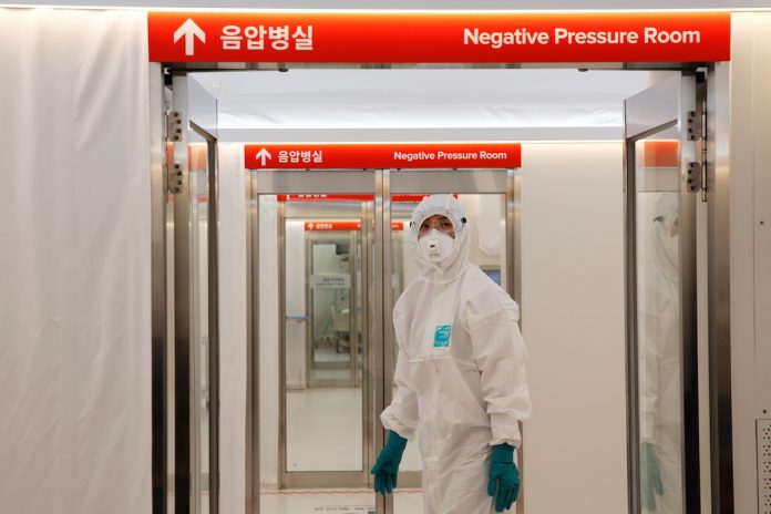 A medical worker checks the doors inside the Mobile Clinic Module outside Korea Cancer Center Hospital in Seoul, South Korea, Jan. 8. (Photo by Heo Ran/Reuters)