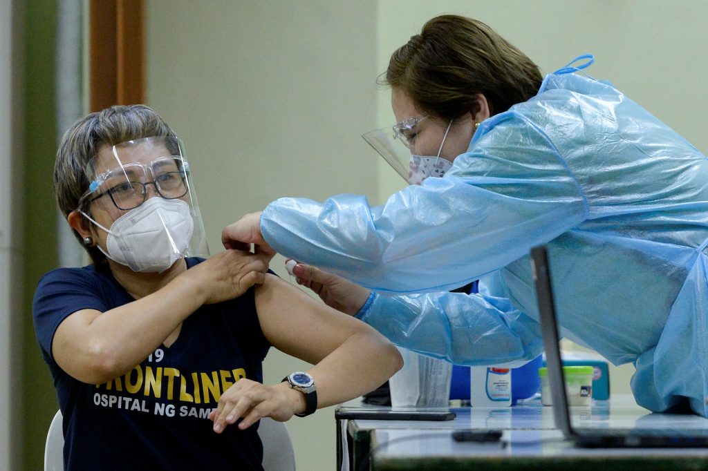 A health worker conducts mock vaccination during a simulation exercise for the coronavirus disease vaccination activities, at the Universidad de Manila, in Manila on Jan. 19, 2021. (Photo by Lisa Marie David/Reuters)