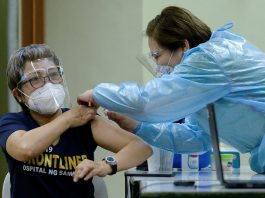 A health worker conducts mock vaccination during a simulation exercise for the coronavirus disease vaccination activities, at the Universidad de Manila, in Manila on Jan. 19, 2021. (Photo by Lisa Marie David/Reuters)