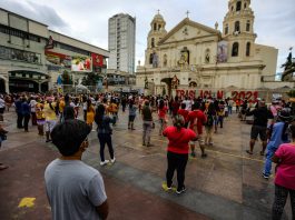Devotees of the Black Nazarene stand outside the church in Manila's Quiapo district to hear Mass on Jan. 3, 2021. Mass gatherings, including religious services, are prohibited due to existing health protocols during the pandemic. (Photo by Jire Carreon)
