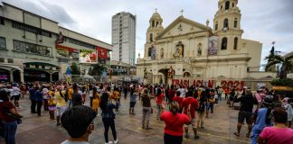 Devotees of the Black Nazarene stand outside the church in Manila's Quiapo district to hear Mass on Jan. 3, 2021. Mass gatherings, including religious services, are prohibited due to existing health protocols during the pandemic. (Photo by Jire Carreon)