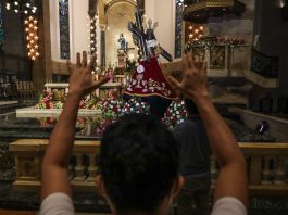 A devotee prays before the image of the Black Nazarene at the Manila Cathedral during the 'pilgrim visit' in Jan. 3, 2021. (Photo by Jire Carreon)