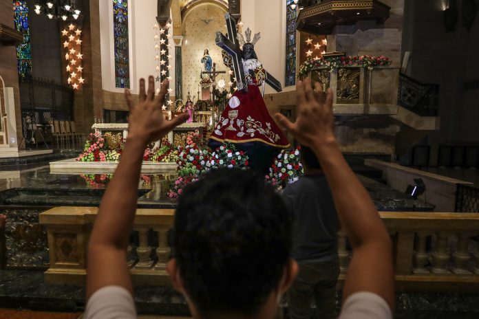 A devotee prays before the image of the Black Nazarene at the Manila Cathedral during the 'pilgrim visit' in Jan. 3, 2021. (Photo by Jire Carreon)