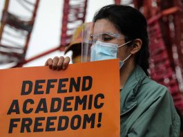 An activist holds a sign calling for academic freedom during a demonstration inside the University of the Philippines campus in Quezon City on Jan. 19, 2021. (Photo by Jire Carreon)