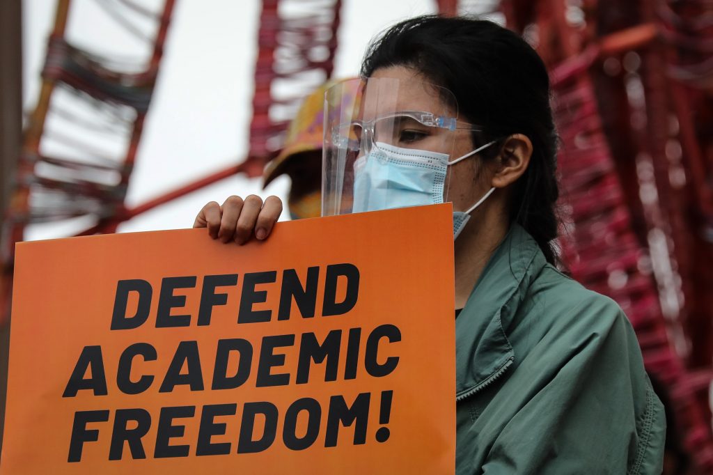 A protester holds a sign calling for academic freedom during a demonstration inside the University of the Philippines campus in Quezon City on January 19, 2021. The protesters denounced the abrogation of a deal that bars soldiers and policemen from entering campuses without notifying school officials. (Photo by Jire Carreon for LiCAS.news)