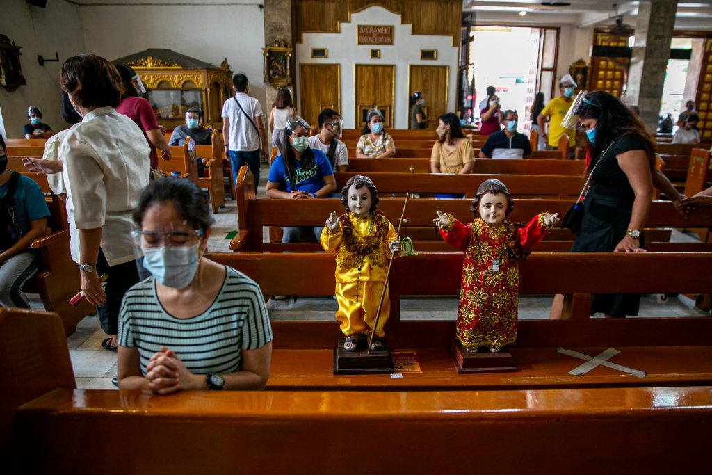 Images of the Santo Niño or the Child Jesus are brought to a church in Quezon City during its ‘feast’ on Jan. 17, 2021. (Photo by Mark Saludes)