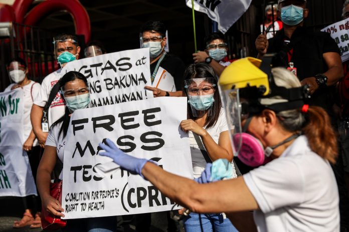 Activists stage a demonstration in Manila on January 29, 2021, to call for sufficient healthcare services, including mass testing for COVID-19 and adequate protection for medical workers. (Photo by Basilio Sepe)