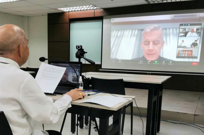 Archbishop Romulo Valles, president of the bishops' conference, listens as Archbishop Charles John Brown, papal nuncio to the Philippines, reads the pope's message during the start of the bishops' online plenary assembly on January 26, 2021. (CBCP News photo)