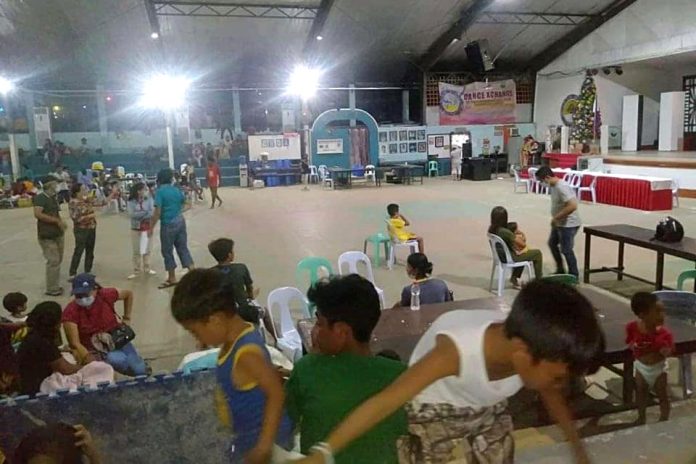 Villagers from Lahug seek temporary shelter at the civic center in Tapaz town, Capiz province, following the killings on Dec. 30. (Photo from CBCP News)