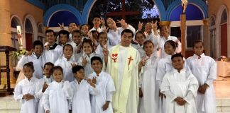 Father Rene Regalado poses with altar servers in this undated photo. (Photo supplied)