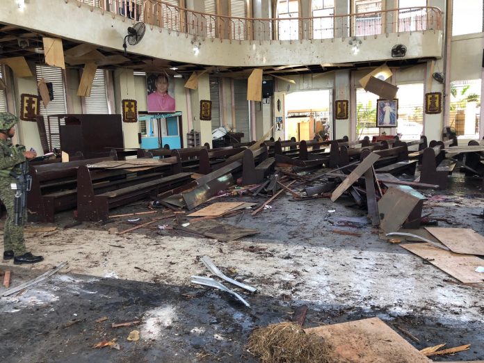 Church pews are scattered inside the Cathedral of Our Lady of Mount Carmel in the southern Philippine town of Jolo after a twin explosion killed at least 20 people and injured about 100 others on Jan. 27, 2019. (Photo courtesy of the Philippine military's Western Mindanao Command)