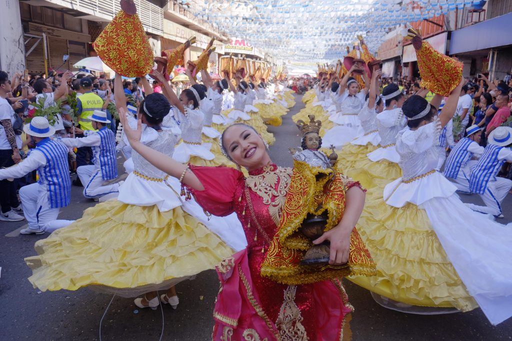 A street performer carries an image of the Child Jesus during the traditional Sinulog Festival in the province of Cebu in honor of the Santo Niño in 2019. (Photo by Victor Kintanar)