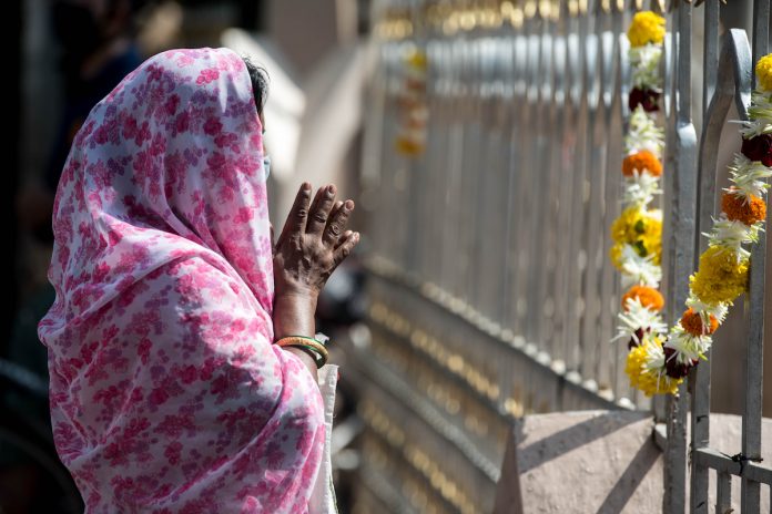 A file image of a Christian praying outside a closed Mumbai church during the COVID-19 pandemic on Sept. 8, 2020. (Photo by Manoej Paateel/shutterstock.com)