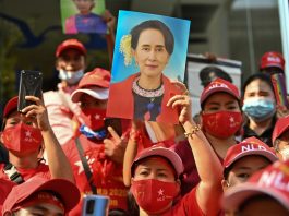 Myanmar migrants hold up portraits of Aung San Suu Kyi as they take part in a demonstration outside the Myanmar embassy in Bangkok on Feb. 1, after Myanmar's military detained the country's de facto leader Suu Kyi and the country's president in a coup. (Photo by Lillian Suwanrumpha/AFP)