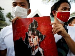 Myanmar citizens hold up a picture of leader Aung San Suu Kyi after the military seized power in a coup in Myanmar, outside United Nations venue in Bangkok, Thailand Feb. 2. (Photo by Jorge Silva/Reuters)