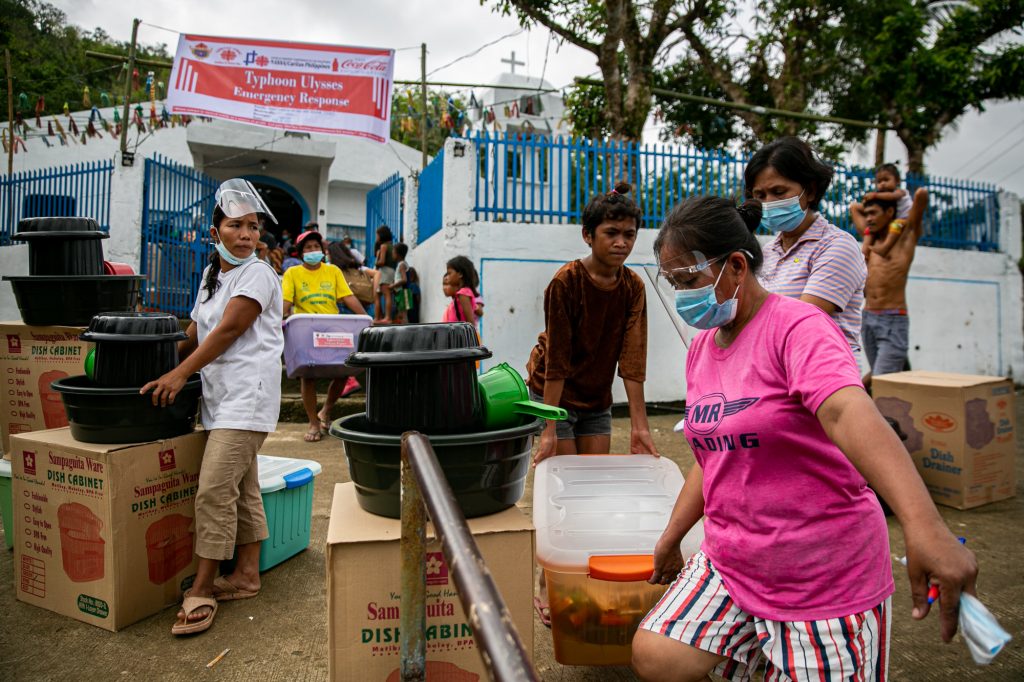 Residents of Ogbong village in Viga town in the province of Catanduanes receive "household starter kits" from the social action arm of the Diocese of Virac on February 2. (Photo by Mark Saludes)